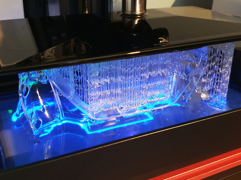 Resin 3D printer with the light on printing a clear part